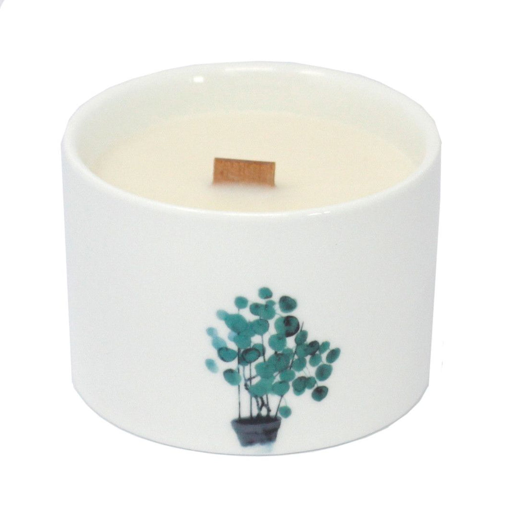 White soy wax candle with blue-green branch bouquet print and centered wick tab