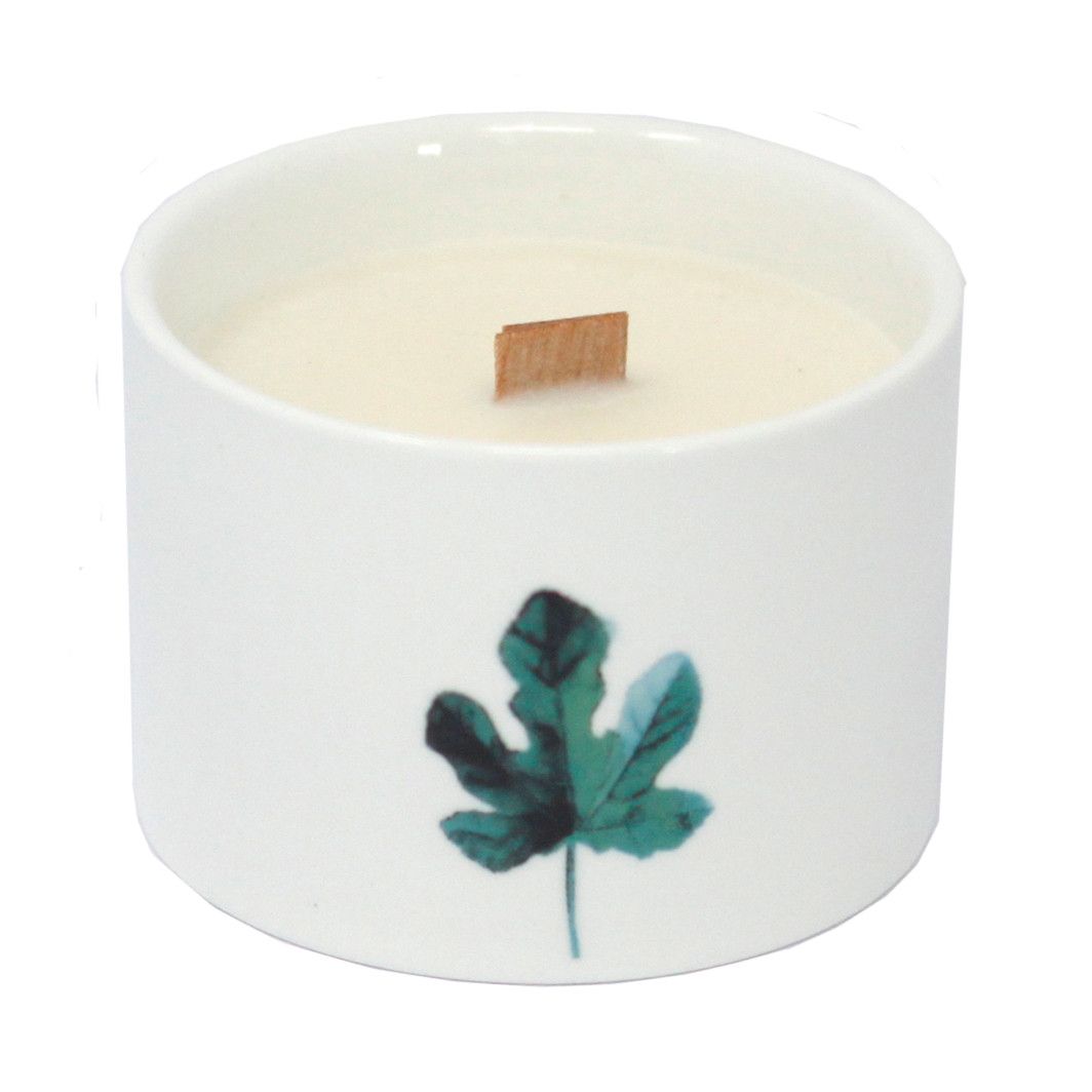 White soy wax candle in a cup with green leaf botanical print and centered wick tab