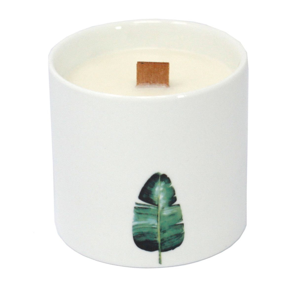 Large white candle jar with green tropical leaf print and wooden wick tab