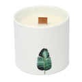 Large white botanical candle with green leaf print and tan wax wick tab