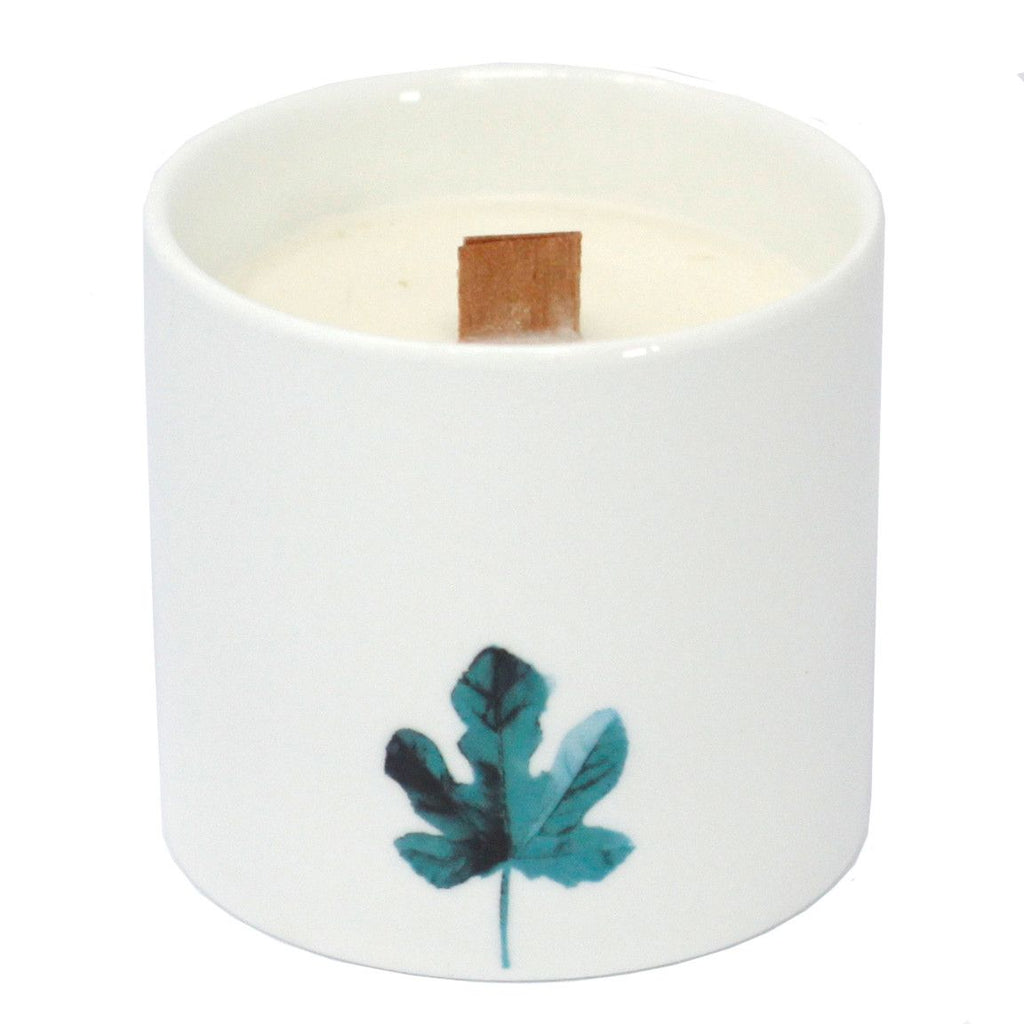 Large white candle jar with teal botanical leaf print and wooden wick tab