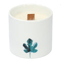 Large white candle jar with teal botanical leaf print and wooden wick tab