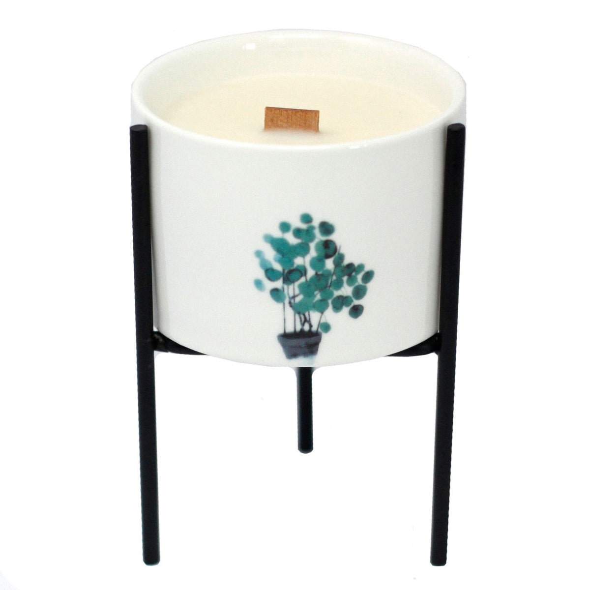 White ceramic candle holder with teal botanical tree print and black iron tripod stand